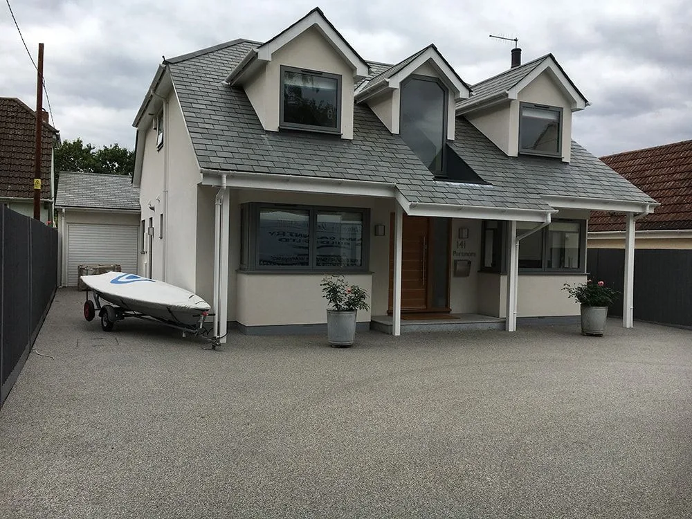Chalet-style house with dormer windows and a resin driveway