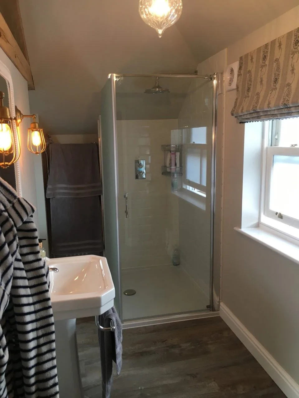 Glass shower enclosure in a compact bathroom