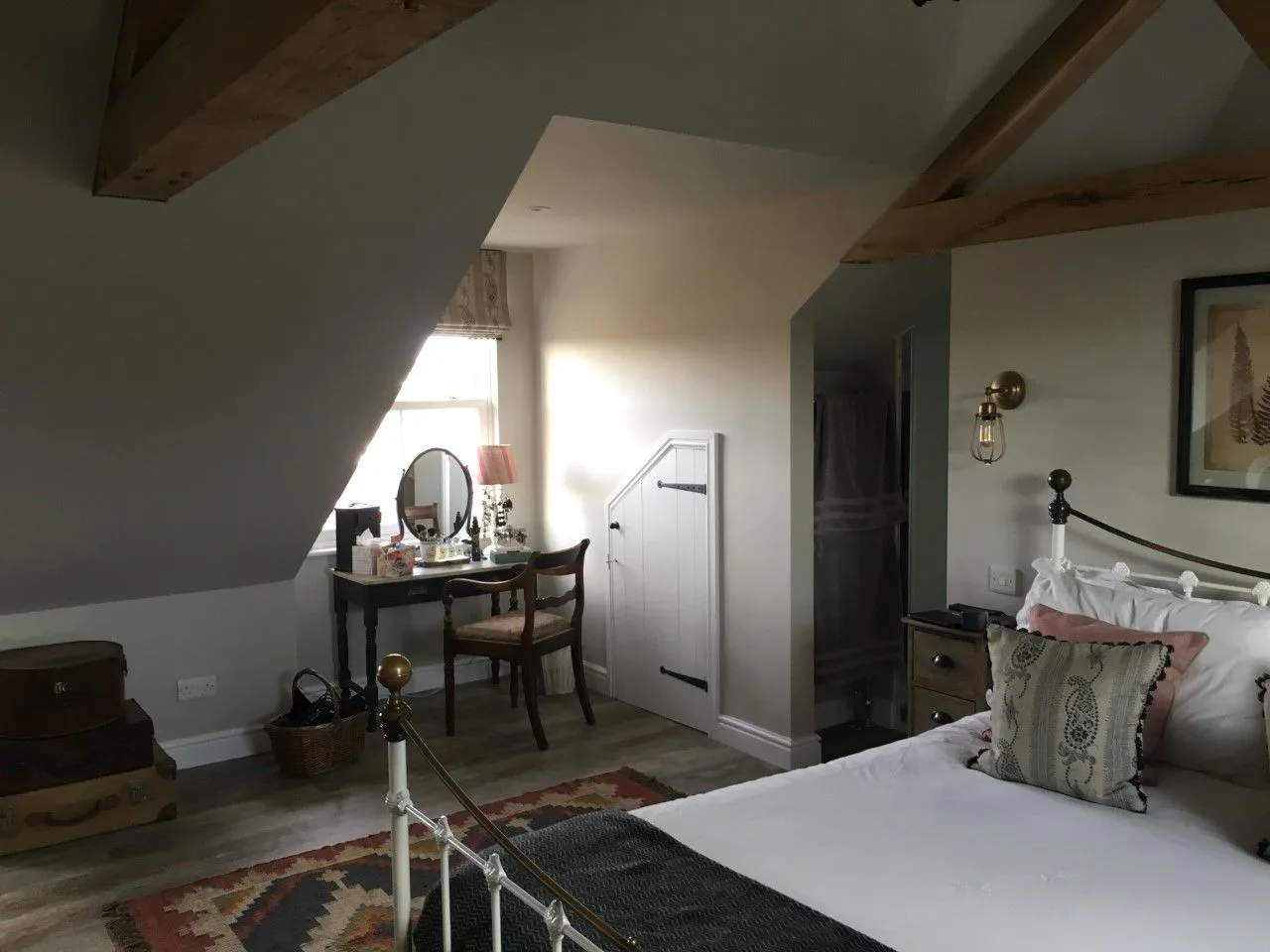 Loft bedroom with a desk under the eaves
