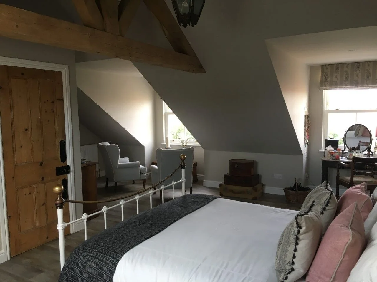 Loft bedroom with a window seat under a vaulted ceiling