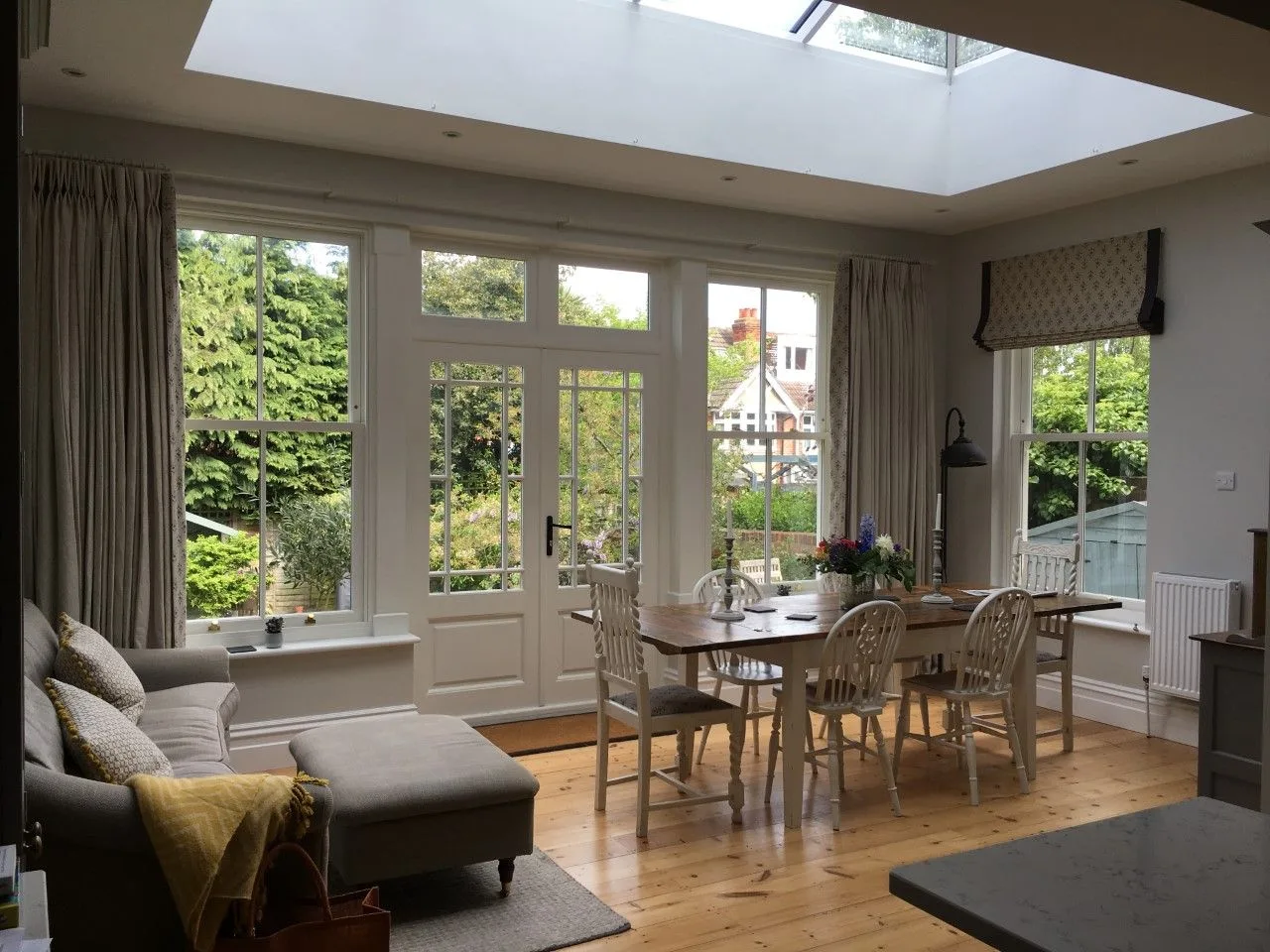 Open-plan living and dining room with a roof lantern and garden doors