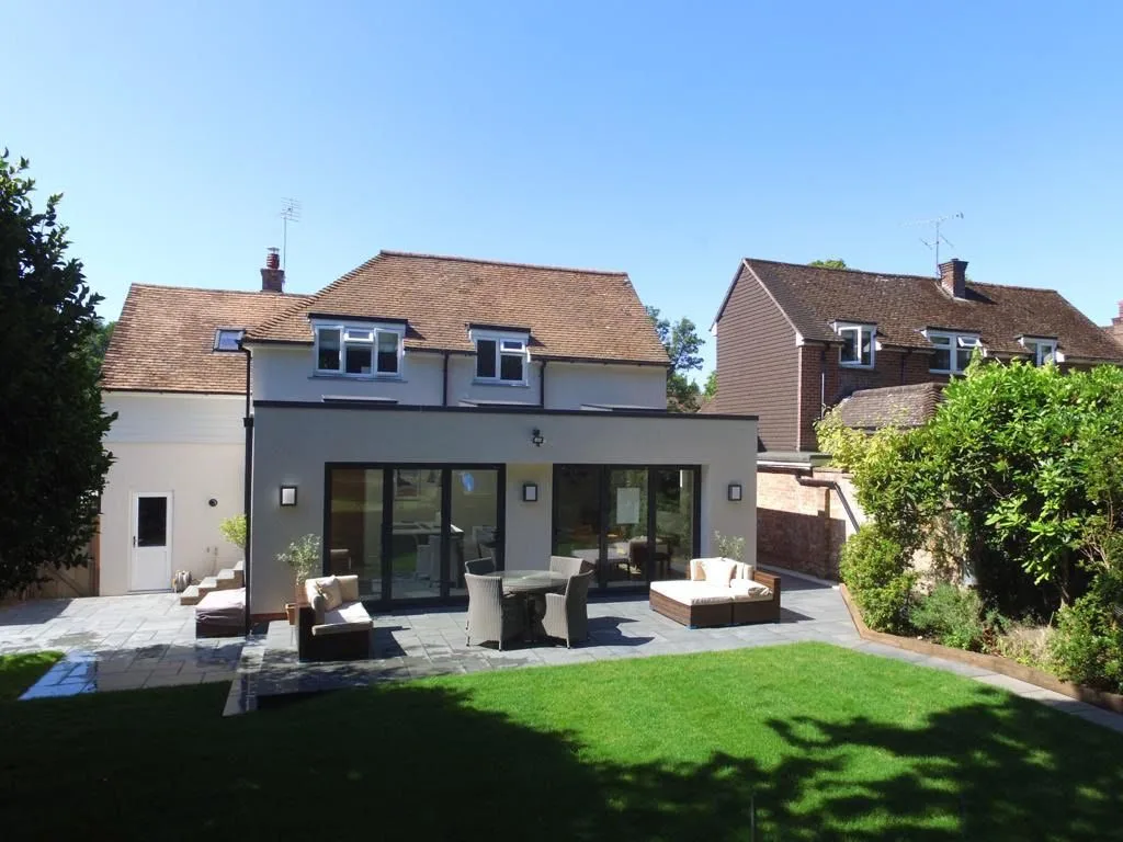 Rendered rear extension with sliding doors and a new garden terrace