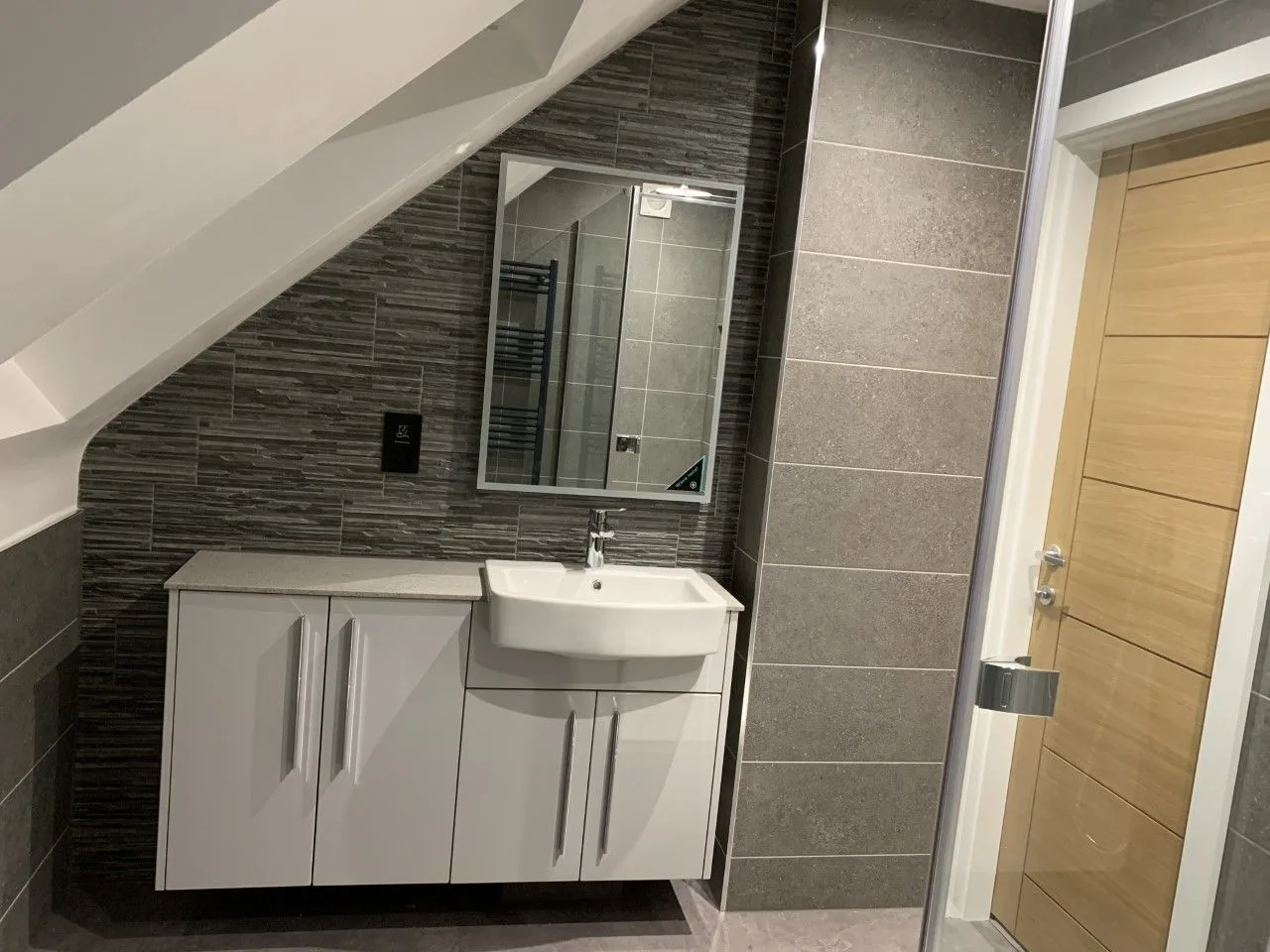Shower room with a vanity unit and grey tiles
