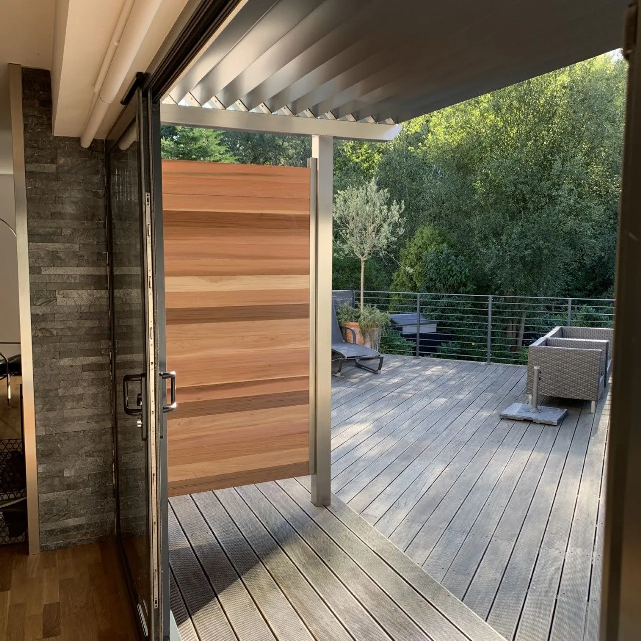 Timber decking and a cedar-clad screen on a rear terrace