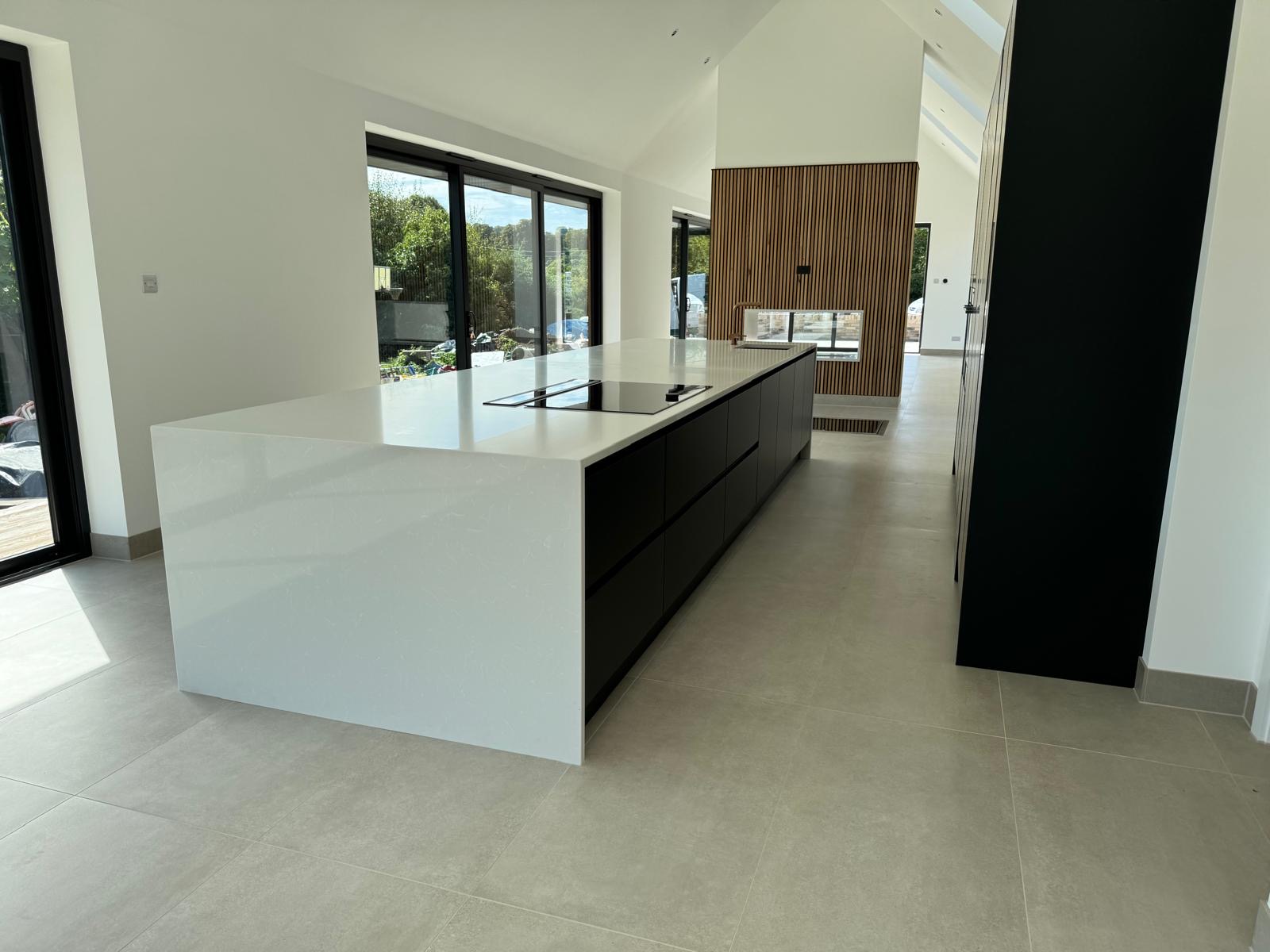 Professional kitchen fitters installing custom wood flooring